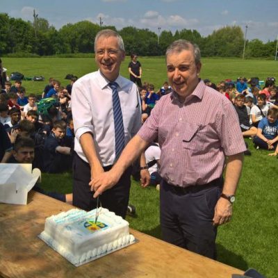 Mr O'Leary & Bish principal Mr Ciaran Doyle, cut the latter's retirement cake...